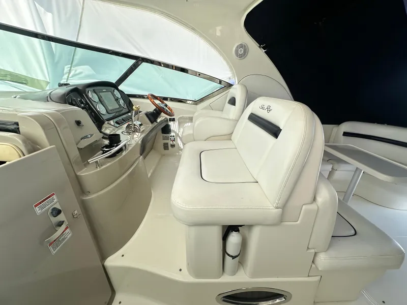 Slide: The Image of Interior of 2007 Sea Ray 380 Sundancer with white seating and control panel. - 11