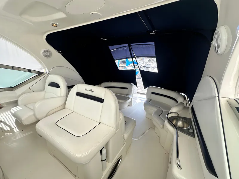 Slide: The Image of 2007 Sea Ray 380 Sundancer interior with white seating and dark blue canopy. - 12