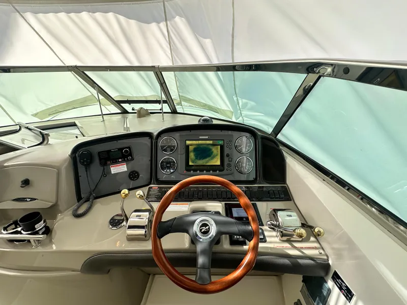 Slide: The Image of Helm of 2007 Sea Ray 380 Sundancer with wood steering wheel and navigation system. - 15