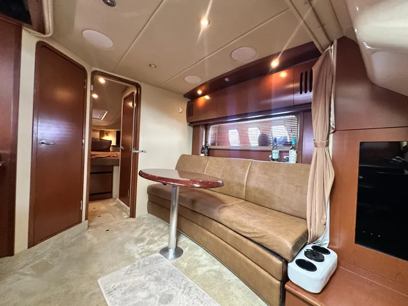 Slide: The Image of Interior of 2007 Sea Ray 380 Sundancer yacht with beige seating and wooden accents. - 18