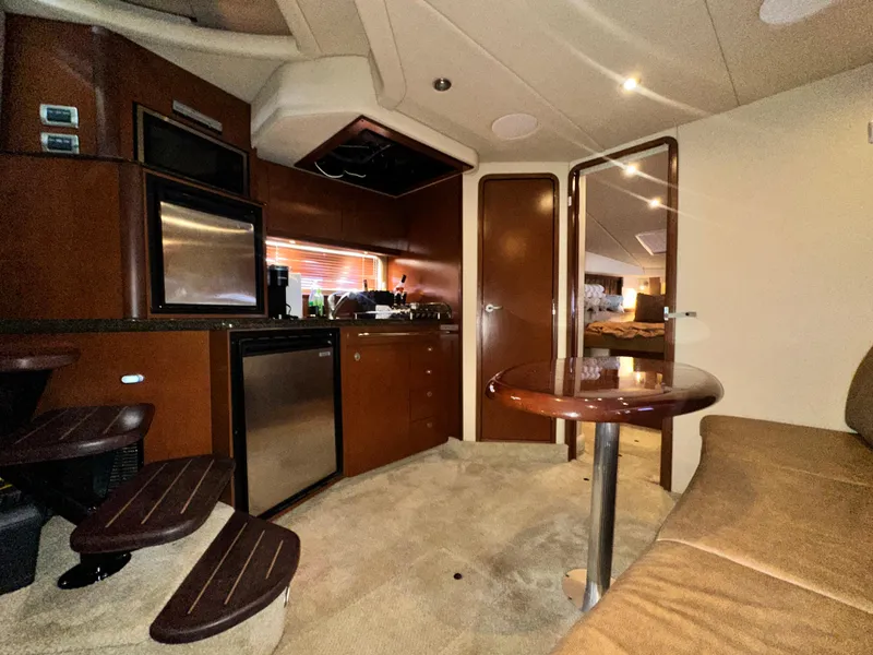 Slide: The Image of Interior of 2007 Sea Ray 380 Sundancer yacht with kitchen and seating area. - 19