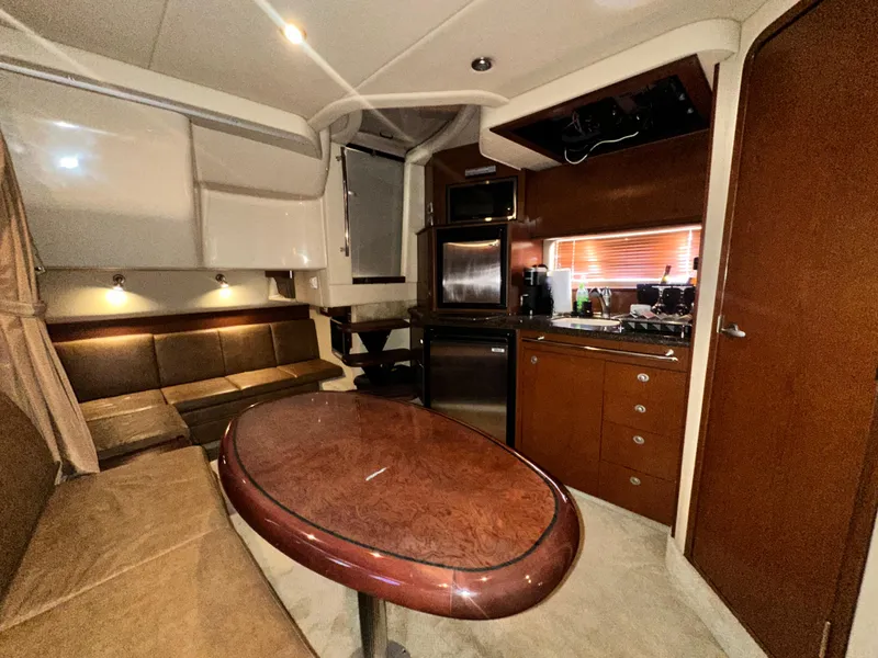 Slide: The Image of Interior of 2007 Sea Ray 380 Sundancer yacht with modern kitchen and seating area. - 21
