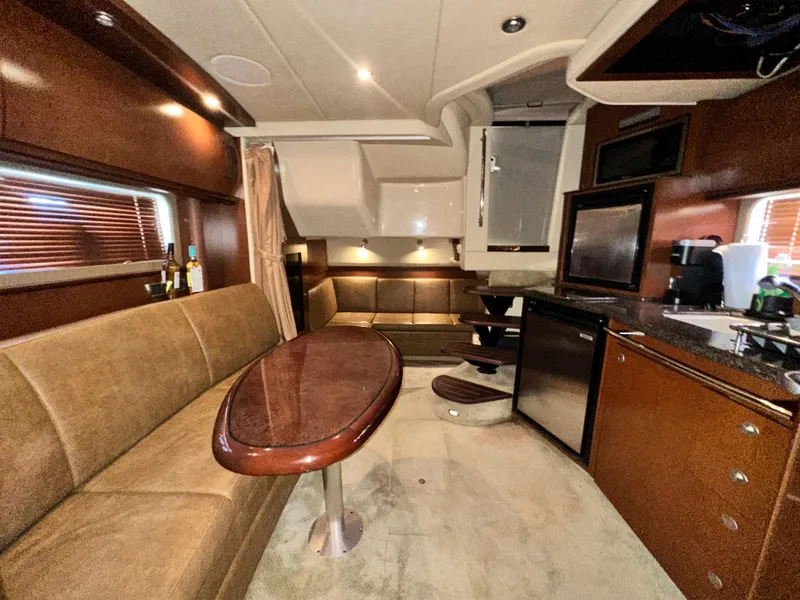Slide: The Image of Luxurious interior of 2007 Sea Ray 380 Sundancer yacht with elegant seating and kitchenette. - 22
