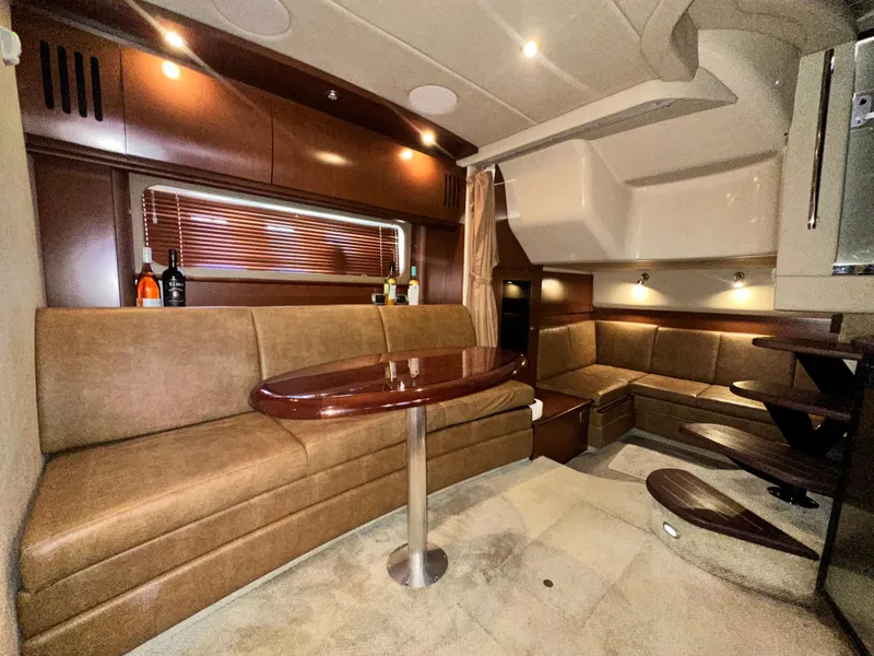 Slide: The Image of Luxurious interior of 2007 Sea Ray 380 Sundancer yacht with elegant seating and wooden table. - 23