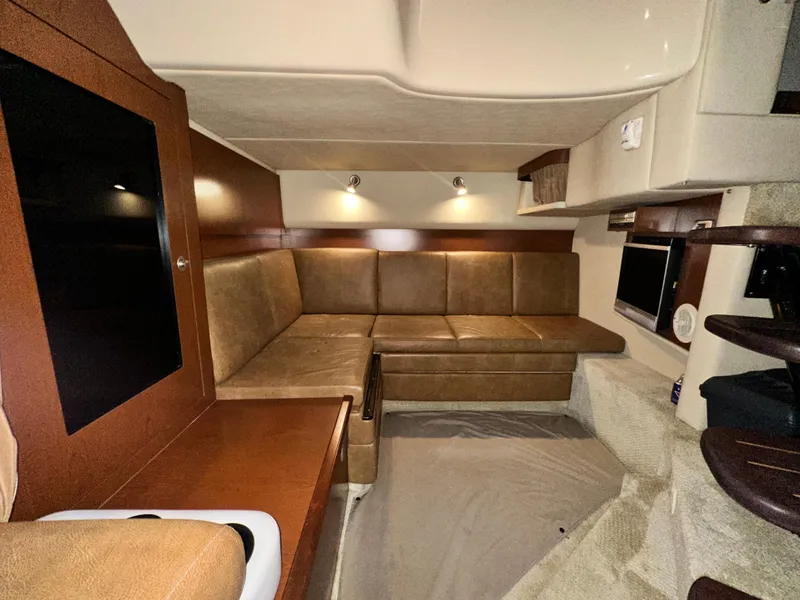 Slide: The Image of Interior of 2007 Sea Ray 380 Sundancer with leather seating and modern amenities. - 25