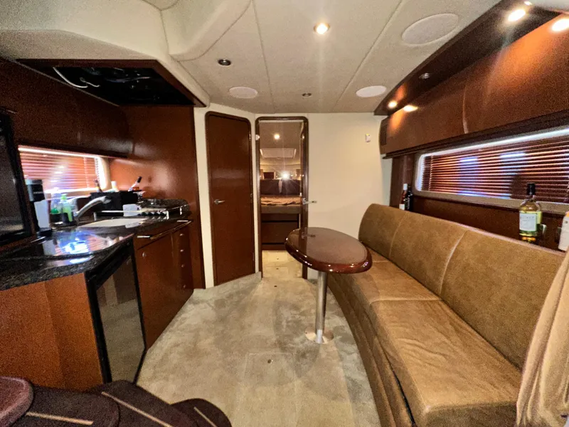 Slide: The Image of Interior of 2007 Sea Ray 380 Sundancer yacht with modern kitchen and seating area. - 26