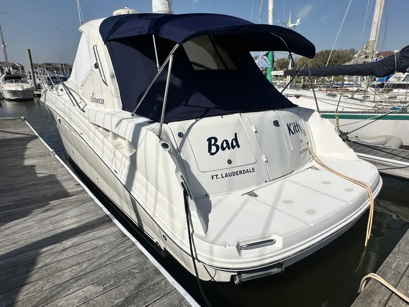 Slide: The Image of 2007 Sea Ray 380 Sundancer docked, featuring blue canopy and "Bad Kitty" name. - 3