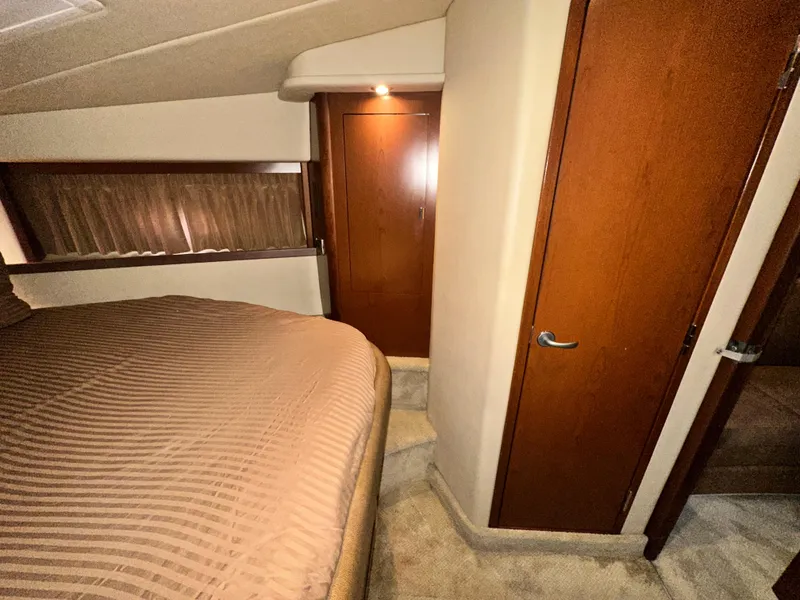 Slide: The Image of Interior cabin of 2007 Sea Ray 380 Sundancer with wood paneling and bed. - 30