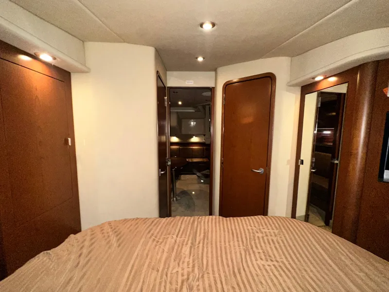 Slide: The Image of Interior cabin of 2007 Sea Ray 380 Sundancer yacht, featuring wood finishes and cozy lighting. - 31