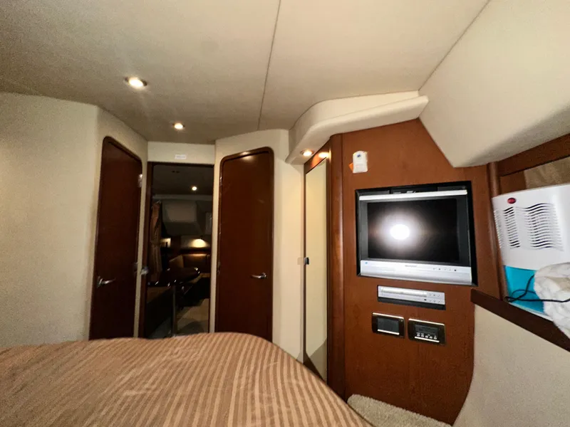 Slide: The Image of Interior of 2007 Sea Ray 380 Sundancer yacht with TV and wooden cabinetry. - 32