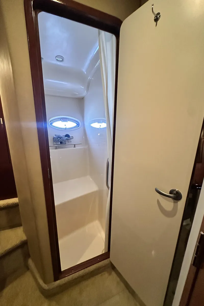 Slide: The Image of 2007 Sea Ray 380 Sundancer bathroom interior with shower and porthole window. - 36
