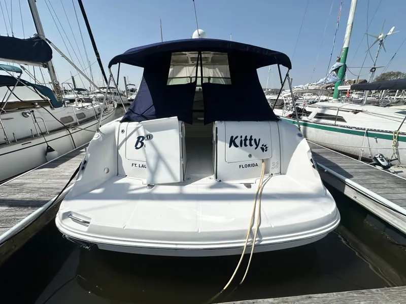 Slide: The Image of 2007 Sea Ray 380 Sundancer docked at marina, rear view with blue canopy. - 4