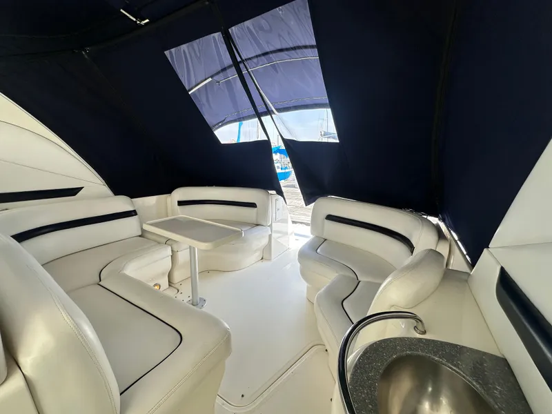 Slide: The Image of Interior of 2007 Sea Ray 380 Sundancer with white seating and table. - 8