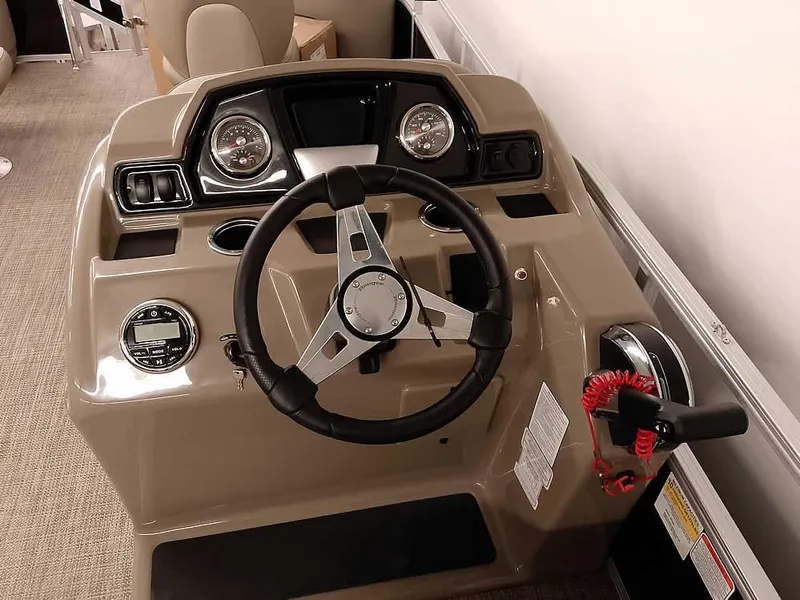Slide: The Image of 2023 Ranger Reata 200F Pontoon dashboard with steering wheel and controls. - 18