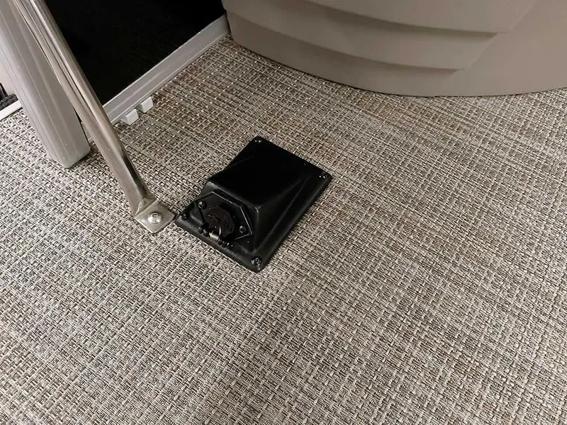 Slide: The Image of 2023 Ranger Reata 200F Pontoon interior with textured flooring and black fixture. - 26