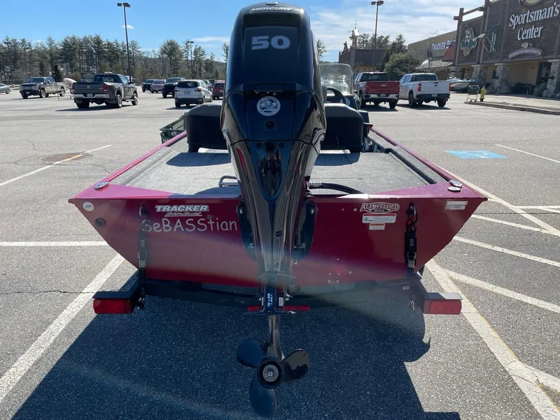 Slide: The Image of 2024 Tracker Bass Tracker Classic XL boat with 50 HP motor in parking lot. - 2