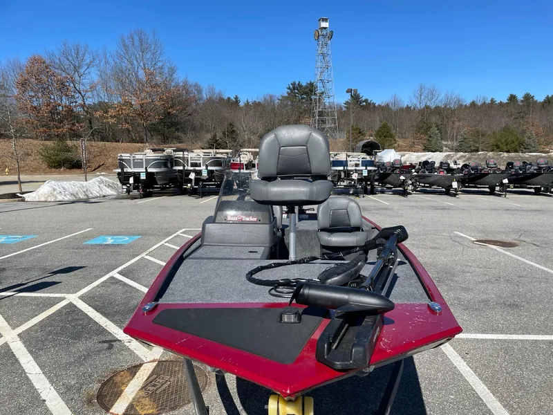 Slide: The Image of 2024 Tracker Bass Tracker Classic XL boat in parking lot, featuring red and gray design. - 3