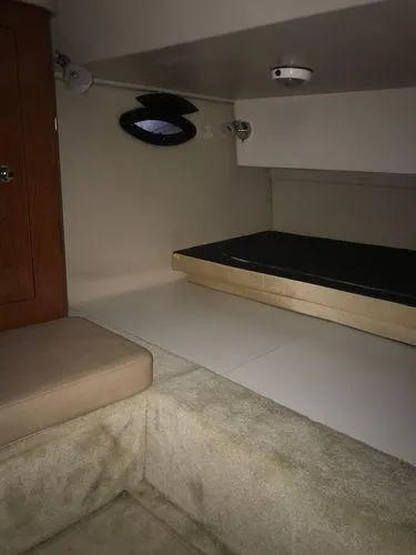 Slide: The Image of 2010 Regal 2700 Commodore cabin interior with bed and seating area. - 12