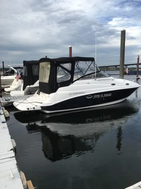 Slide: The Image of 2010 Regal 2700 Commodore boat docked at marina under cloudy sky. - 3