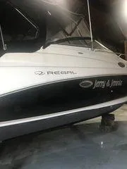 Slide: The Image of 2010 Regal 2700 Commodore boat in a dimly lit indoor setting. - 4