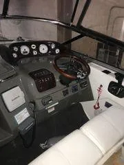 Slide: The Image of Interior view of 2010 Regal 2700 Commodore boat cockpit with steering wheel and controls. - 5