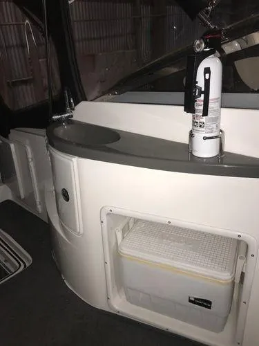 Slide: The Image of 2010 Regal 2700 Commodore interior with fire extinguisher and storage compartment. - 7