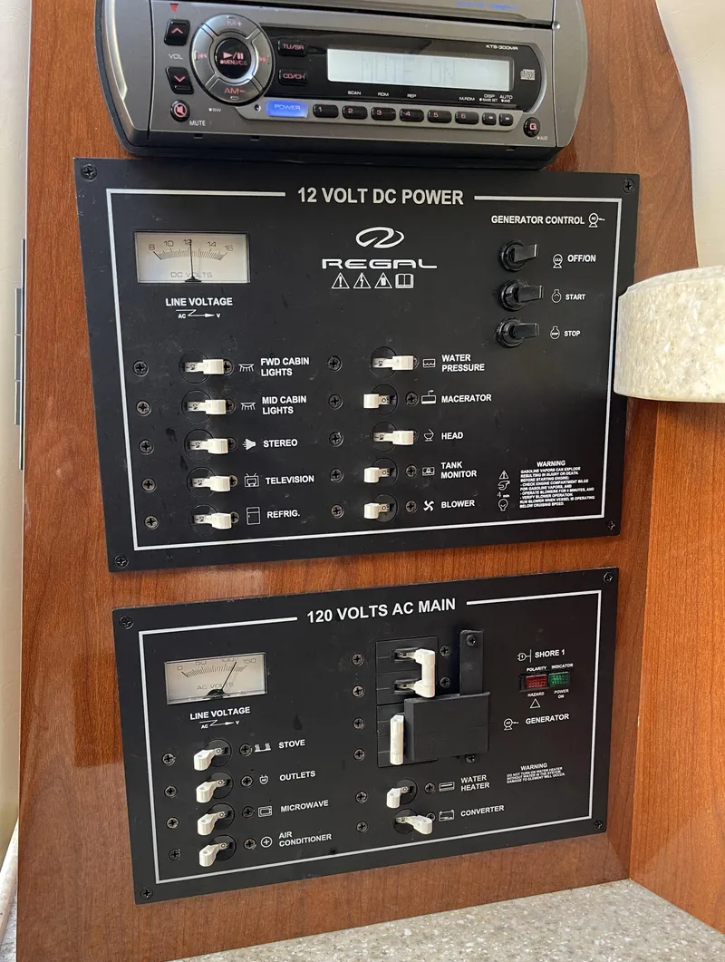 Slide: The Image of 2010 Regal 2700 Commodore control panel with 12V DC and 120V AC power switches. - 9