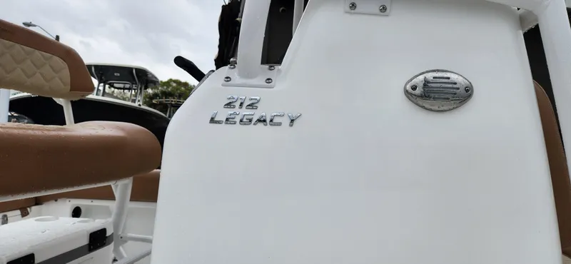 Slide: The Image of 2025 NauticStar 212 Legacy boat, white exterior with brown seating. - 10