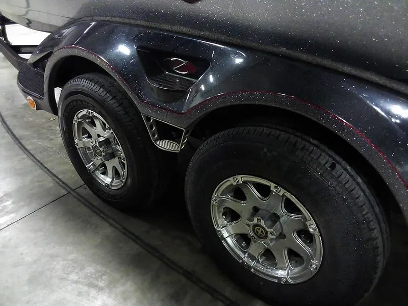 Slide: The Image of 2013 Ranger Z520C Comanche trailer with dual chrome wheels in a garage setting. - 10