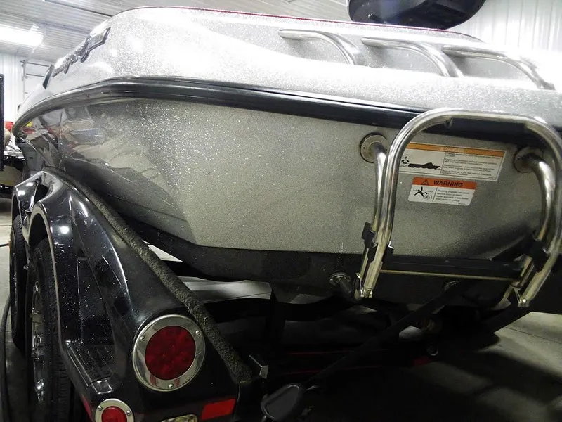 Slide: The Image of 2013 Ranger Z520C Comanche boat on trailer, rear view in a garage. - 11
