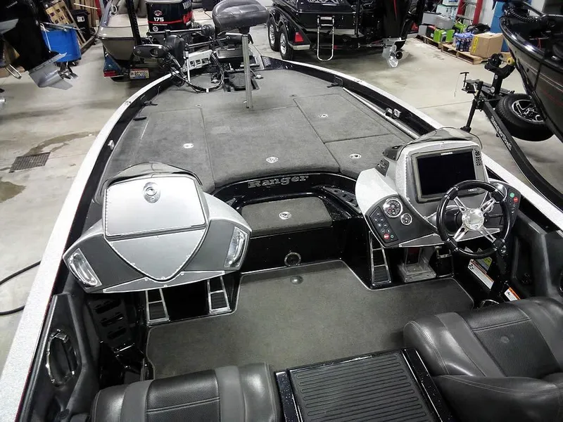 Slide: The Image of 2013 Ranger Z520C Comanche boat interior with steering console and seating. - 13