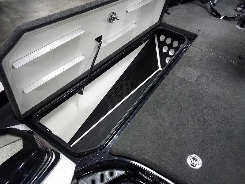 Slide: The Image of 2013 Ranger Z520C Comanche boat storage compartment, open lid, spacious interior, organized layout. - 19