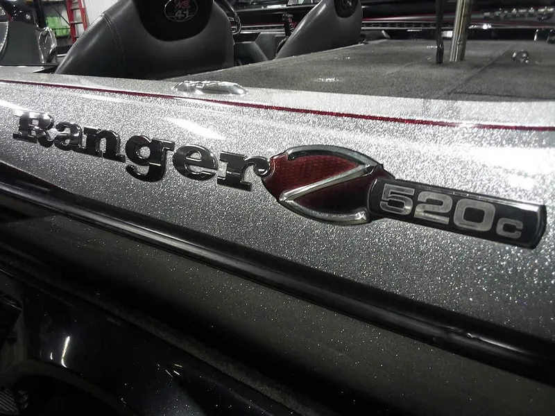 Slide: The Image of 2013 Ranger Z520C Comanche boat logo on metallic surface. - 3