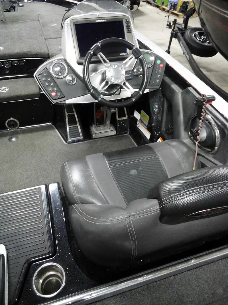 Slide: The Image of 2013 Ranger Z520C Comanche boat cockpit with steering wheel and control panel. - 34