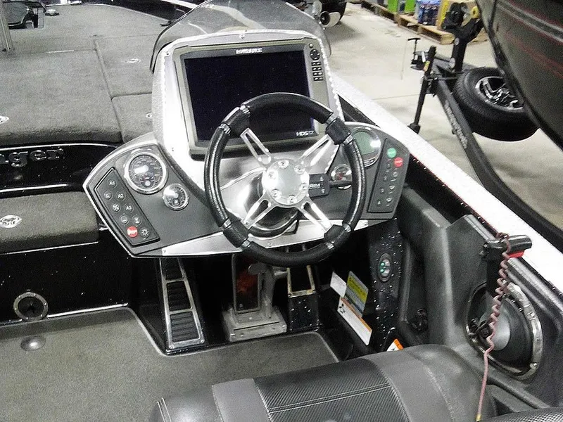 Slide: The Image of 2013 Ranger Z520C Comanche boat cockpit with steering wheel and control panel. - 35