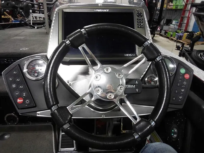 Slide: The Image of 2013 Ranger Z520C Comanche boat dashboard with steering wheel and Lowrance HDS-12 display. - 37