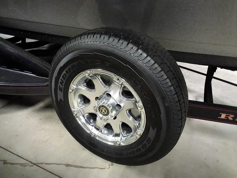 Slide: The Image of 2013 Ranger Z520C Comanche trailer wheel with chrome rim and black tire. - 46