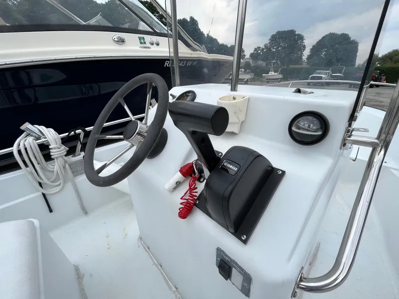 Slide: The Image of 1994 Boston Whaler 15 Dauntless boat console with steering wheel and controls. - 11