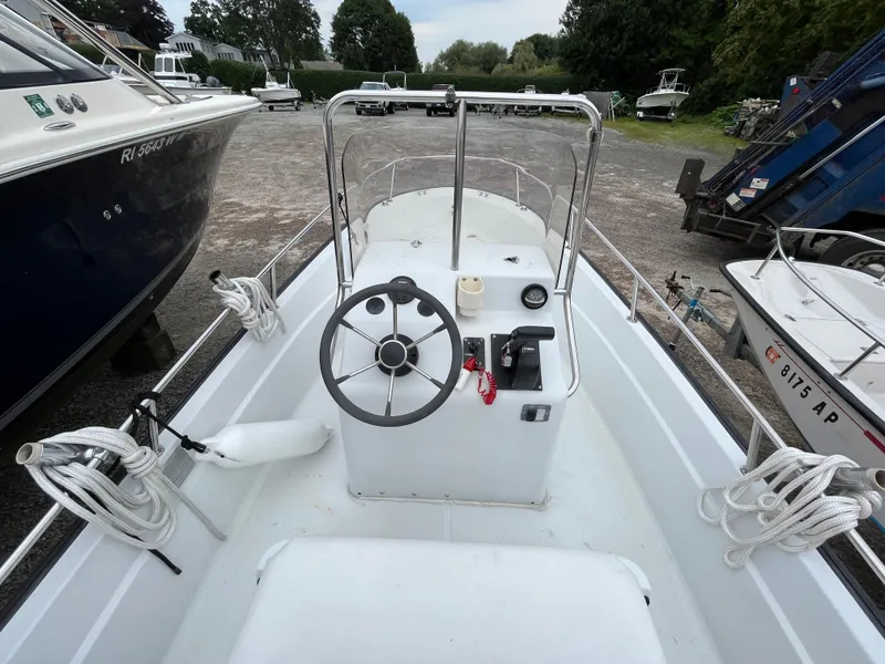 Slide: The Image of 1994 Boston Whaler 15 Dauntless boat interior with steering wheel and controls. - 13