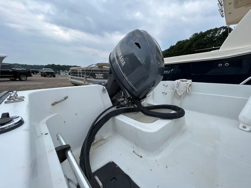 Slide: The Image of 1994 Boston Whaler 15 Dauntless boat with Yamaha outboard motor, docked outdoors. - 7