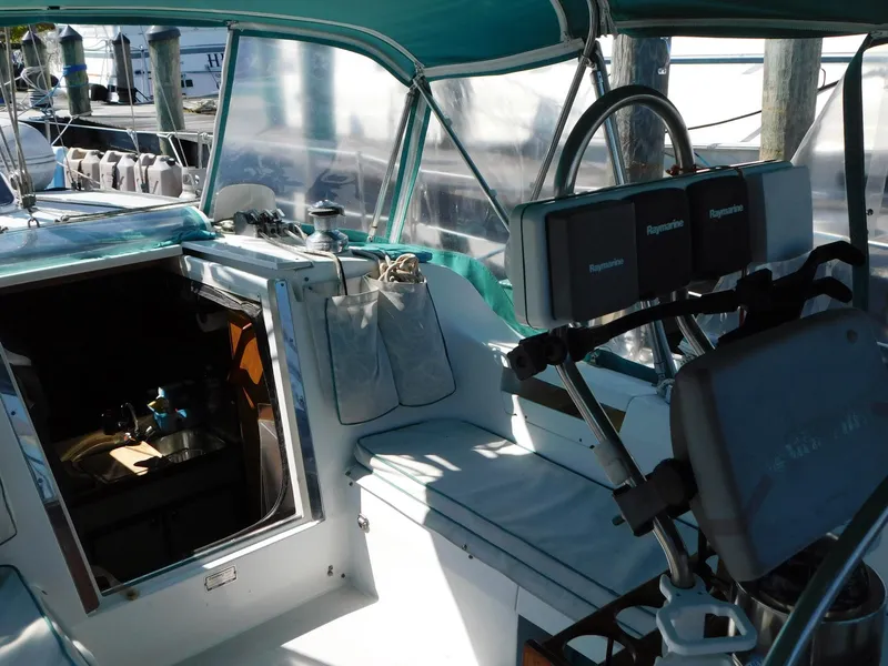 Slide: The Image of Cockpit of a 1998 Catalina 34 Mark II sailboat with navigation equipment and seating. - 11