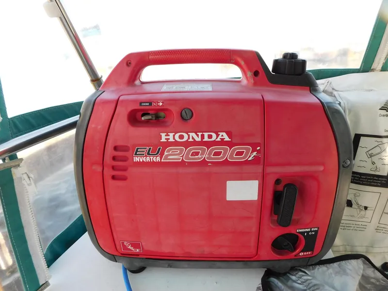 Slide: The Image of Red Honda EU2000i inverter generator on a 1998 Catalina 34 Mark II boat. - 13