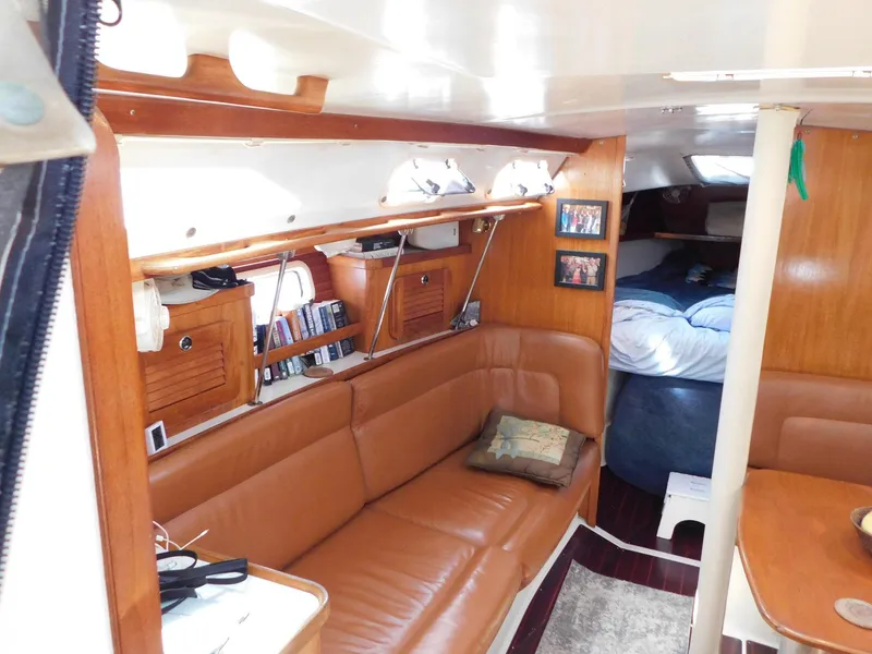 Slide: The Image of Interior of 1998 Catalina 34 Mark II sailboat with cozy seating and wooden accents. - 15
