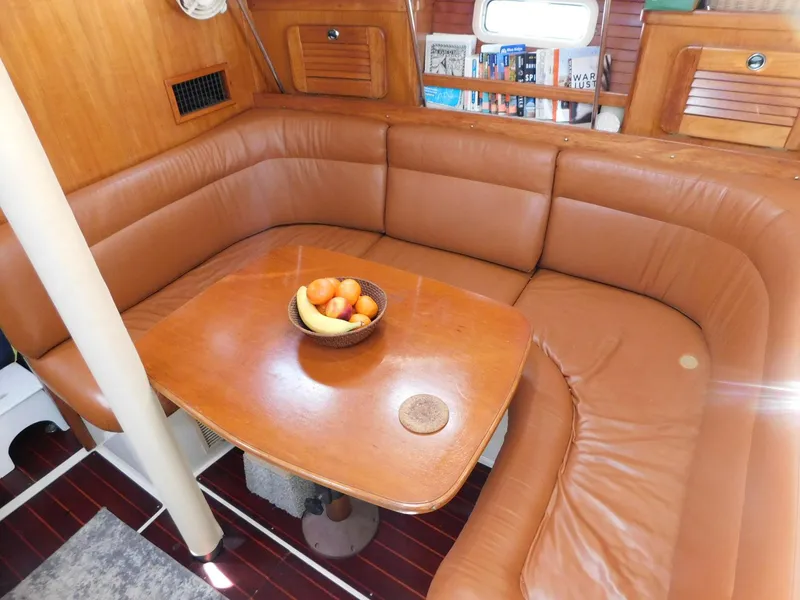 Slide: The Image of Interior of 1998 Catalina 34 Mark II sailboat with leather seating and wooden table. - 16