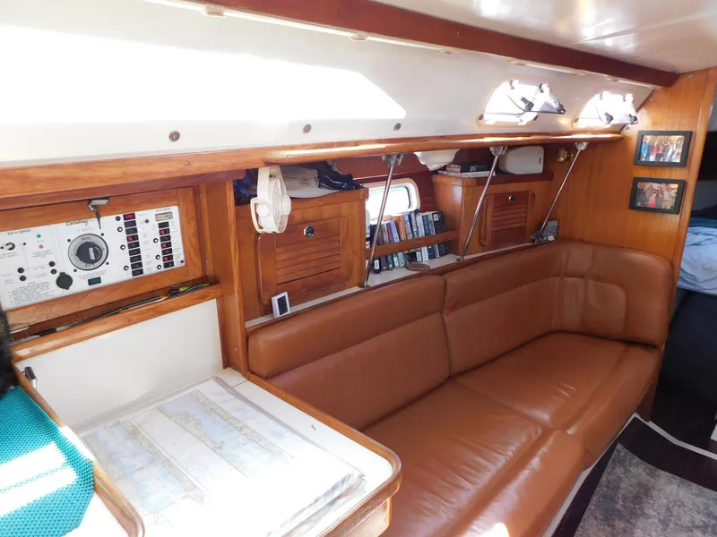 Slide: The Image of Interior of 1998 Catalina 34 Mark II sailboat with leather seating and navigation equipment. - 19