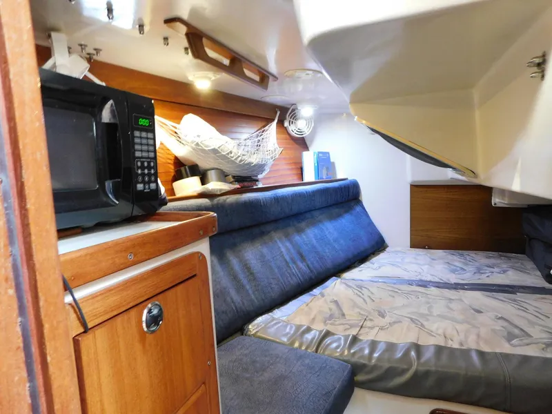 Slide: The Image of Interior of 1998 Catalina 34 Mark II sailboat with cozy seating and microwave. - 25