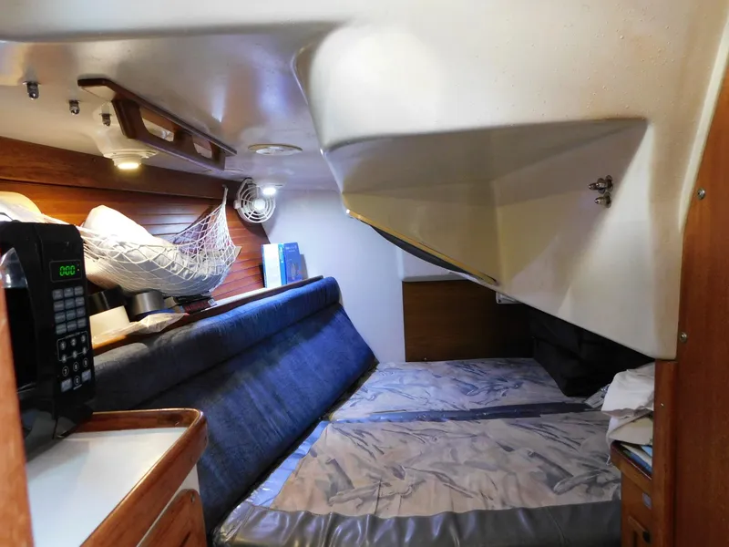 Slide: The Image of Interior cabin of a 1998 Catalina 34 Mark II sailboat, featuring a cozy sleeping area. - 26