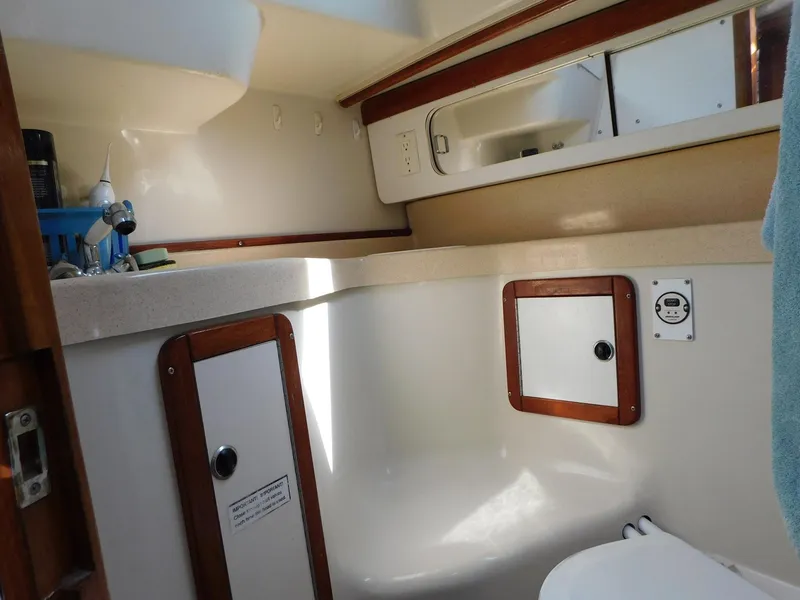Slide: The Image of Interior of 1998 Catalina 34 Mark II sailboat bathroom with storage cabinets. - 27