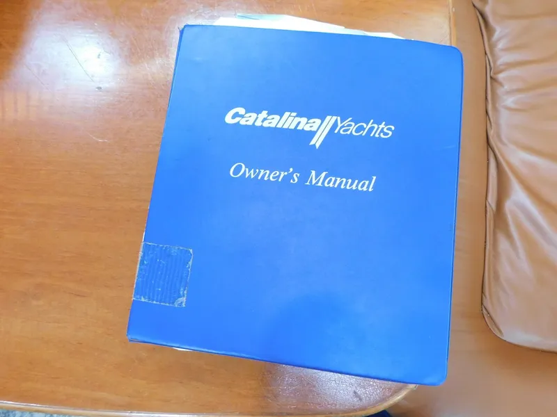 Slide: The Image of Catalina Yachts 34 Mark II 1998 owner's manual on wooden table. - 29