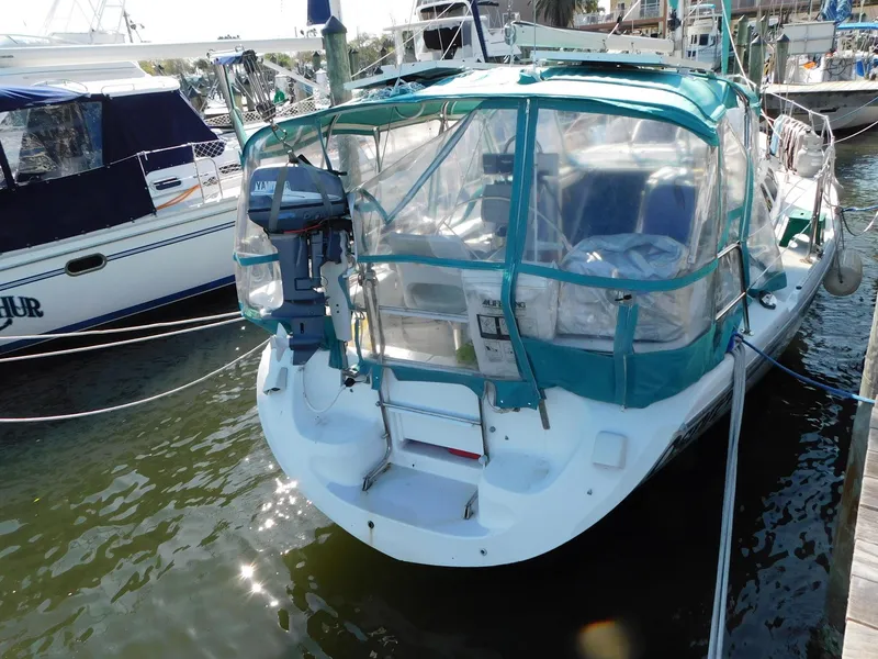 Slide: The Image of 1998 Catalina 34 Mark II sailboat docked with protective canopy and outboard motor. - 3